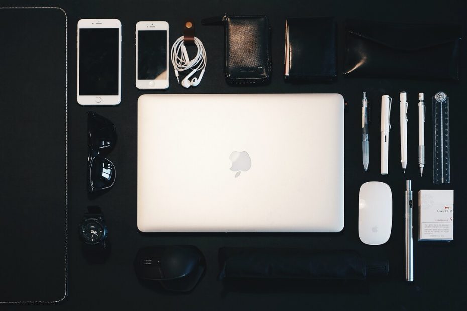 Photo of a carry case for digital items with laptop, mouse, phones, cables, pens by Samule Sun on Unsplash -