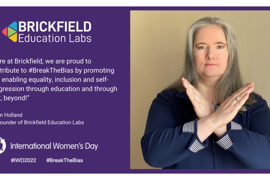 Karen Holland, Co Founder of Brickfield is photographed hands crossed, striking the breaking the bias pose. The text reads "Here at Brickfield, we are proud to contribute to #BreakTheBias by promoting and enabling equality, inclusion and self-progression through education and through that, beyond!"