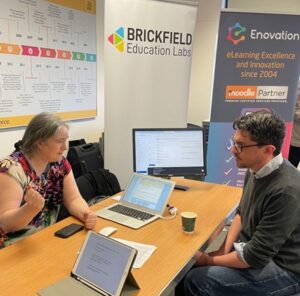 Karen Holland, Co-Founder of Brickfield Education labs explaining what the benefits are of the Moodle Accessibility Toolkit to a conference attendee.