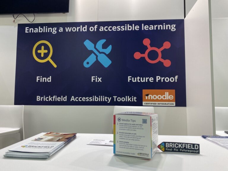 The Brickfield Accessibility Tip Cube, on the Brickfield Exhibition stand table.