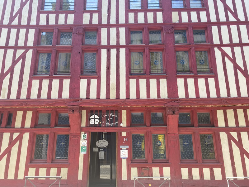 Old building with three floors. The walls are made from half timber and wattle walls, with external red painted wooden beams.