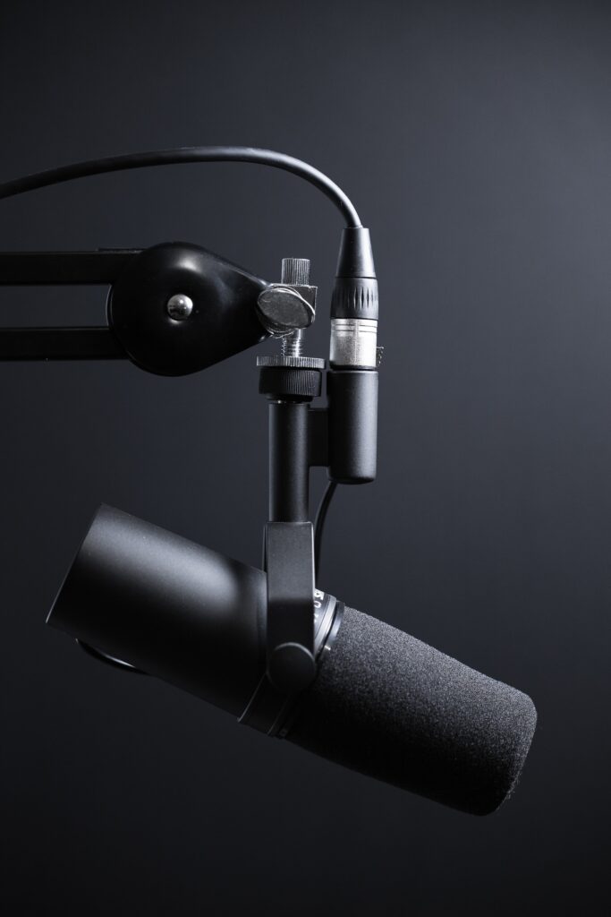 Black podcasting microphone on arm.